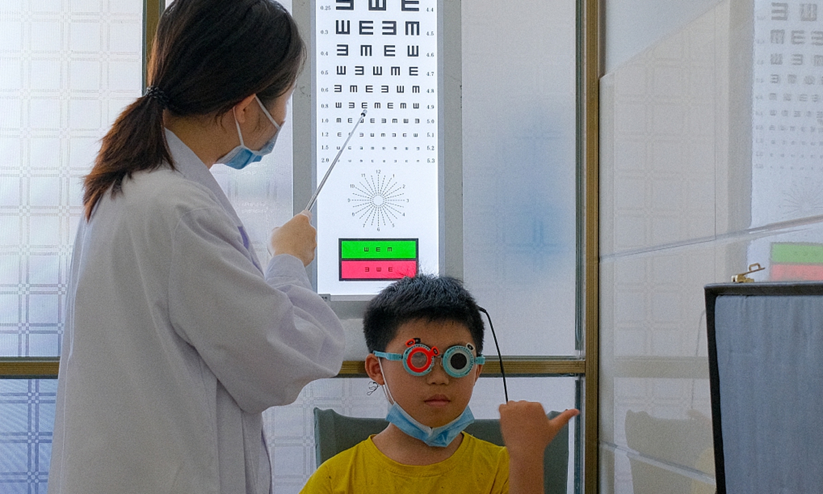 An ophthalmologist checks the eyesight of a child in Yongzhou, Central China's Hunan Province on June 6, 2021, the 26th Chinese National Eye Care Day. Photo: CFP