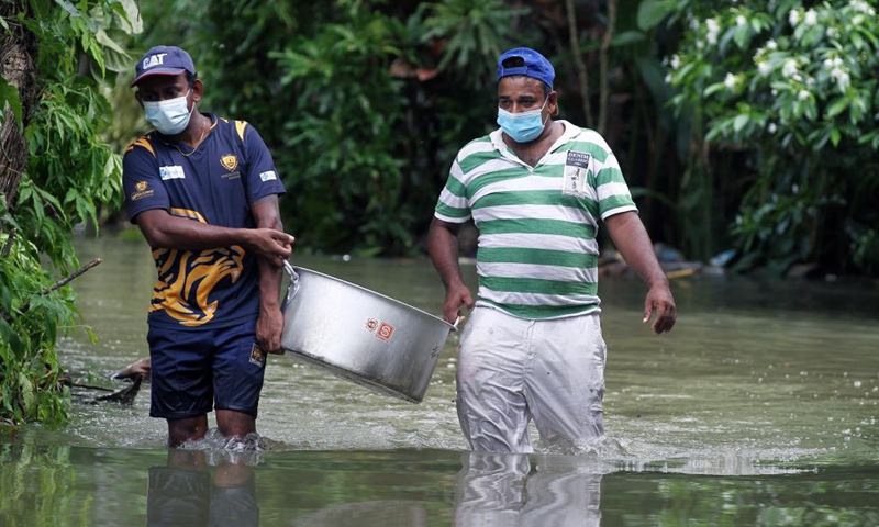 People carry food to be distributed to flood-trapped villagers on the outskirts of Colombo, Sri Lanka, on June 5, 2021. The death toll from Sri Lanka's inclement weather conditions rose to 10 Saturday evening while 219,027 people were affected, the country's Disaster Management Center said.(Photo: Xinhua)