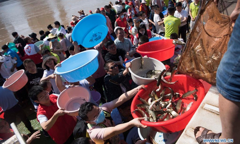 People release fish fry at Juzizhou Park in Changsha, central China's Hunan Province, June 6, 2021. About 80.32 million fish fry were released into the Xiangjiang River in Changsha on Sunday. June 6 has been observed in China as the national fish releasing day to help promote ecological awareness.(Photo: Xinhua)