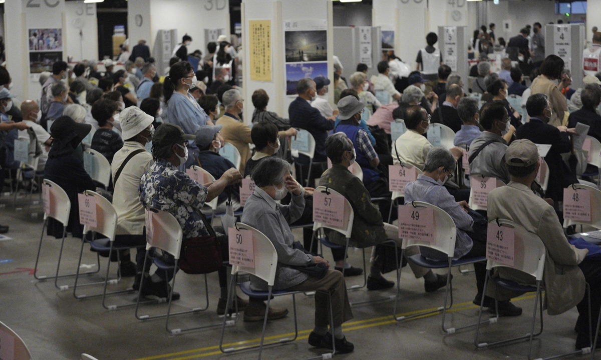 Local residents wait for the Moderna coronavirus vaccine at a mass vaccination center in Yokohama, near Tokyo, Sunday. Over 7000 doses of COVID-19 vaccine have been disposed of in Japan due to mishandling, local media reported. Photo: AP