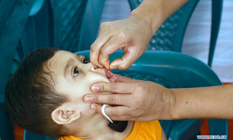 A health professional administers a vitamin A capsule to a child at a health centre in Dhaka, Bangladesh on June 6, 2021. Bangladesh has launched a countrywide campaign to distribute Vitamin A capsules to children between six months and five years of age. Health workers and volunteers were seen Sunday to distribute Vitamin A at thousands of permanent and mobile sites across the country.(Photo: Xinhua)