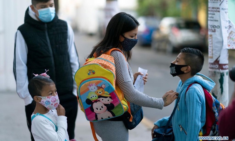 A boy bids goodbye to his mother before entering an elementary school as in-person classes resume in Mexico City, capital of Mexico, on June 7, 2021.(Photo: Xinhua)