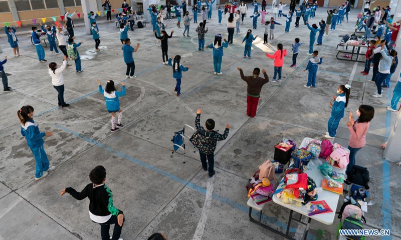 Children do exercises on the school playground as in-person classes resume in Mexico City, capital of Mexico, on June 7, 2021.(Photo: Xinhua)