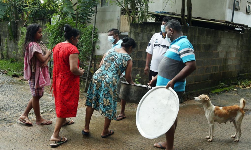 Flood-trapped villagers receive distributed food on the outskirts of Colombo, Sri Lanka, on June 5, 2021. The death toll from Sri Lanka's inclement weather conditions rose to 10 Saturday evening while 219,027 people were affected, the country's Disaster Management Center said.(Photo: Xinhua)