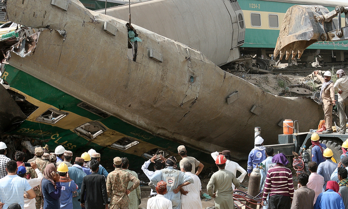 Rescuers arrive at the site of a train accident in the Daharki area of Sindh province on Monday, where at least 40 people were killed and dozens injured when a packed Pakistani inter-city train plowed into another train that had derailed just minutes earlier, officials said. 