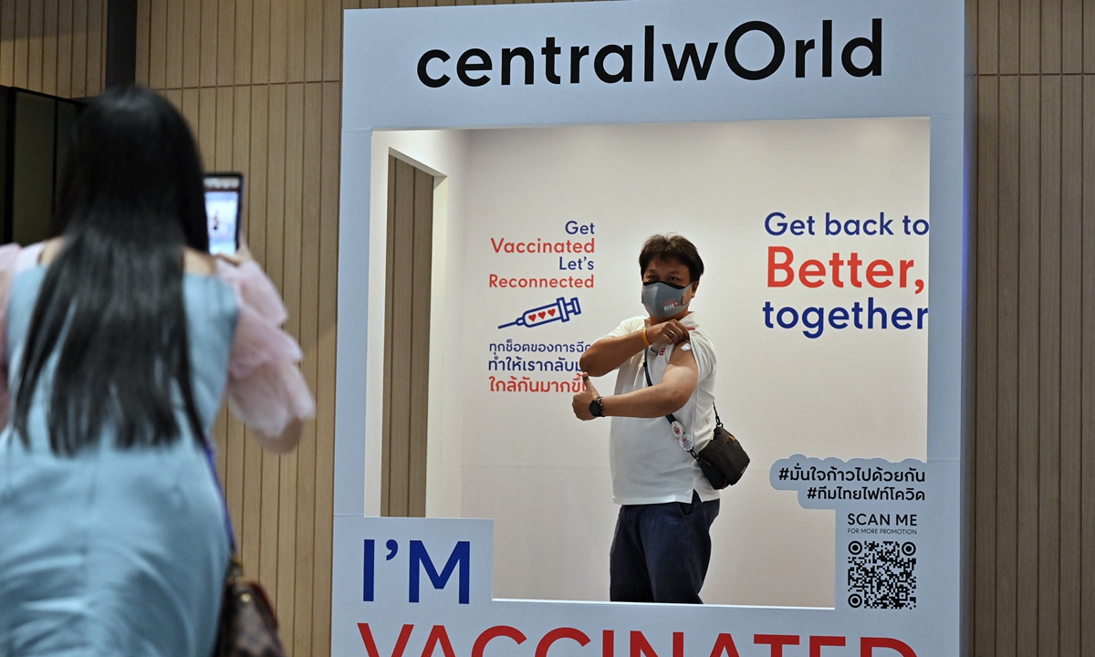 People take pictures after being administered doses of the AstraZeneca COVID-19 vaccine inside the Central World shopping mall in Bangkok on Monday as mass vaccine rollouts begin in Thailand. Photo: AFP