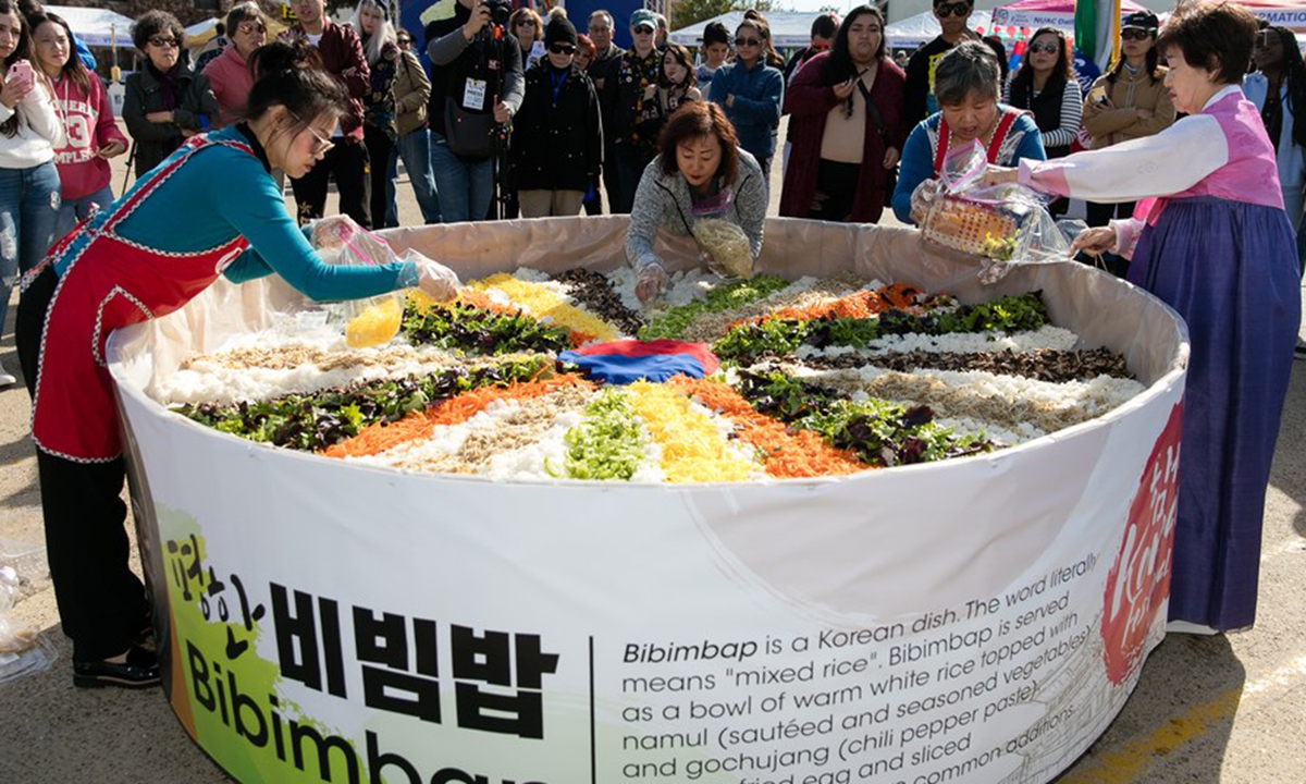 People prepare traditional Korean food Bibimbap during the Korean Festival held in Carrollton, a suburban city of Dallas, Texas, the United States, on Nov. 16, 2019. (Photo by Dan Tian/Xinhua) 