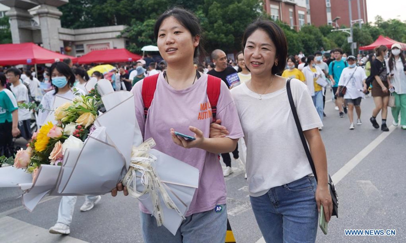 An examinee is greeted by her parent (R, front) while walking out of an exam site at a high school in Nanchang, the capital city of east China's Jiangxi Province, June 8, 2021. Photo: Xinhua