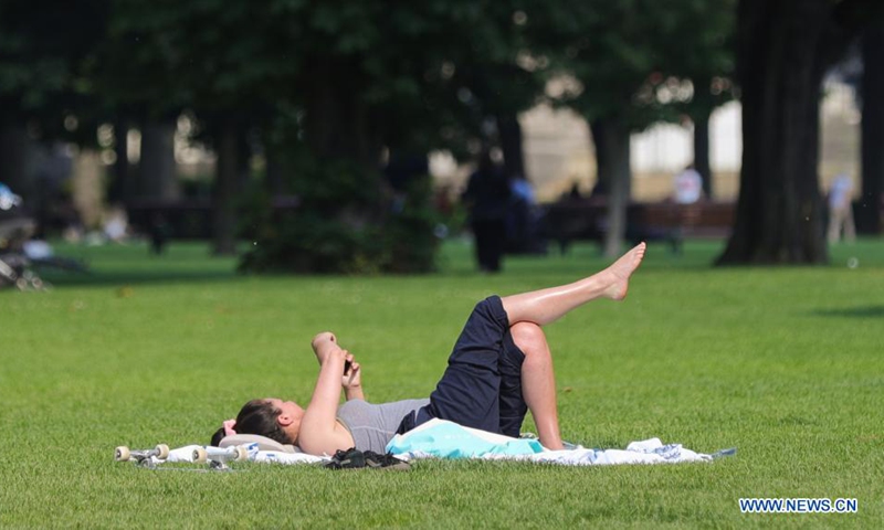 A woman rests in a park in Brussels, Belgium, on June 9, 2021. Belgium's summer plan entered into force on Wednesday. The hospitality sector is allowed to reopen indoor areas from 5 a.m. until closing time at 11:30 p.m. The Consultative Committee in Belgium agreed on new travel rules and relaxation plans on June 4 to allow people to travel safely for their summer holidays. Photo: Xinhua