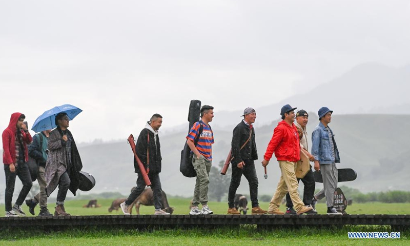 Members of Narat band walk to the performing site of the Narat scenery spot in Xinyuan County of northwest China's Xinjiang Uygur Autonomous Region, June 4, 2021. Photo: Xinhua