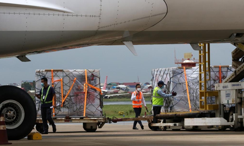 Airport workers unload packages of Chinese COVID-19 vaccines at the Phnom Penh International Airport in Phnom Penh, Cambodia, June 8, 2021.Photo: Xinhua