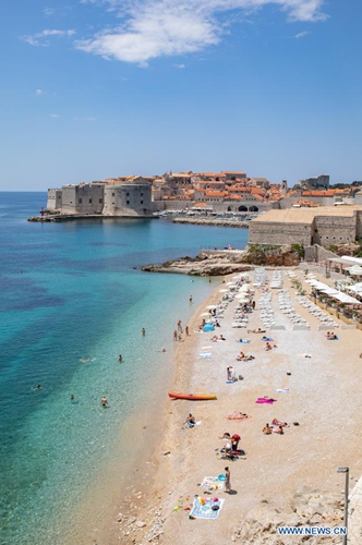 Tourists relax on the beach near the Old Town of Dubrovnik in Dubrovnik, southern Croatia, June 8, 2021.(Photo: Xinhua)