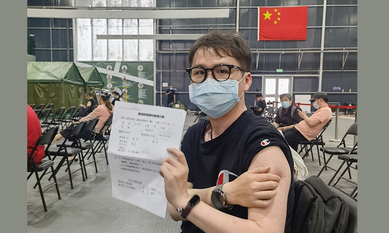 Cheng Po-yu, executive director of the cross-Straits Youth Exchange Association, takes the COVID-19 vaccine in Beijing in late May. Photo: courtesy of Cheng Po-yu