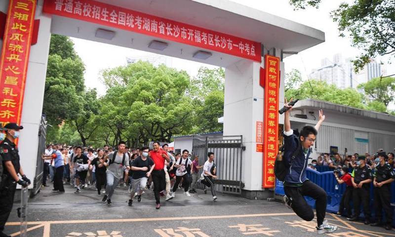 Examinees run out of an exam site at a middle school in Changsha, capital of central China's Hunan Province, June 9, 2021. China's annual college entrance exam concluded on Tuesday in some parts of the country. Photo: Xinhua