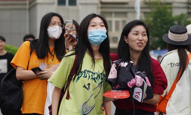 An examinee is greeted by her parent (R, front) while walking out of an exam site at a high school in Nanchang, the capital city of east China's Jiangxi Province, June 8, 2021. Photo: Xinhua