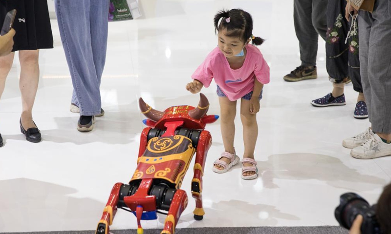 A child interacts with a cattle-shaped robot at the second China-Central and Eastern European Countries (CEEC) Expo in Ningbo, east China's Zhejiang Province, June 9, 2021. The expo opened to public visitors on Wednesday. Themed Fostering a New Development Paradigm, Sharing a Win-Win Opportunity, the expo aims to boost trade between China and Central and Eastern European Countries (CEECs). Photo: Xinhua