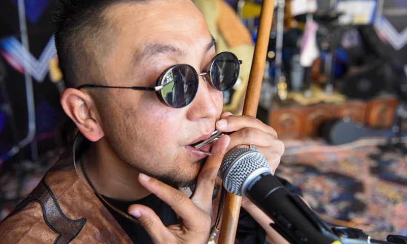 A member of Narat band performs at the Narat scenery spot in Xinyuan County of northwest China's Xinjiang Uygur Autonomous Region, June 3, 2021. Photo: Xinhua
