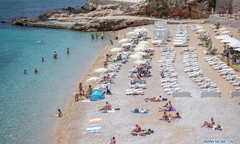 Tourists relax on the beach near the Old Town of Dubrovnik in Dubrovnik, southern Croatia, June 8, 2021.(Photo: Xinhua)