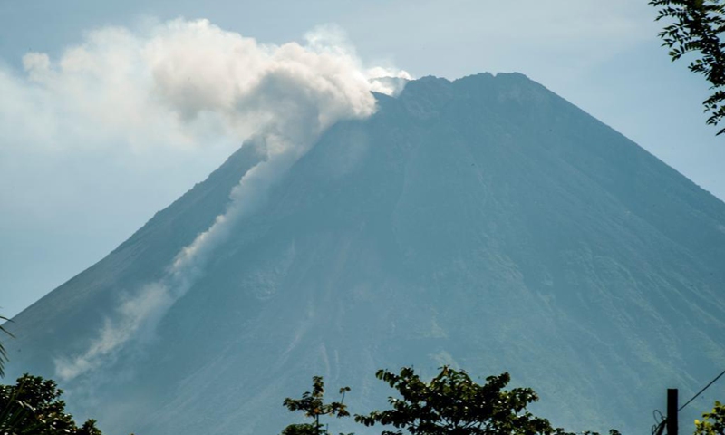 Photo taken on June 8, 2021 shows smoke spewing from Mount Merapi as seen from Kaliurang in Sleman district, Yogyakarta, Indonesia. (Photo by Supriyanto/Xinhua)