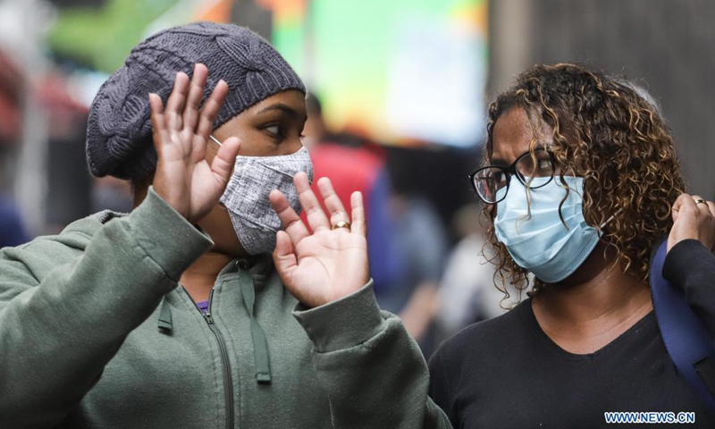 A woman gestures while walks on the street amid COVID-19 outbreak in Sao Paulo, Brazil on June 8, 2021.(Photo: Xinhua)