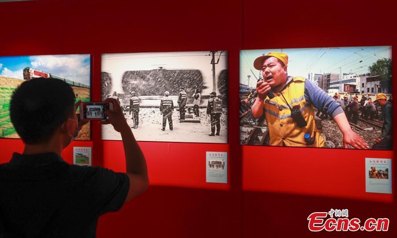 A visitor takes photos at the National Railway Photography Exhibition held in China Railway Museum, Beijing, June 8, 2021.  Photo: China News Service