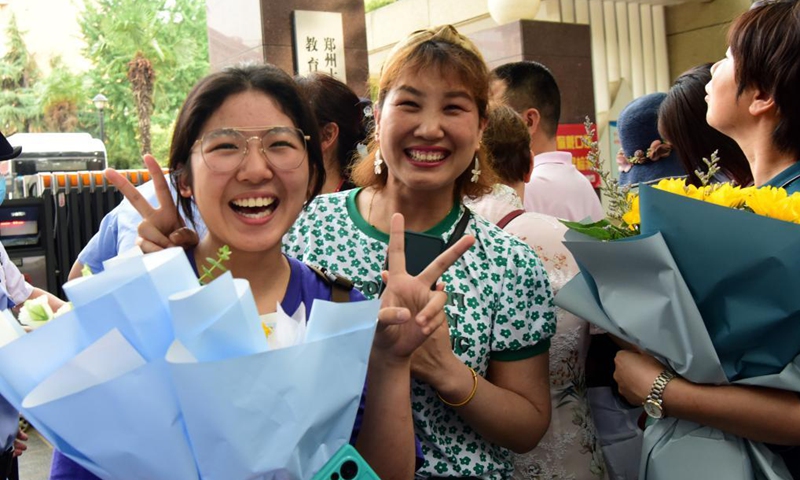 An examinee is greeted by her parent while walking out of an exam site at a high school in Zhengzhou, the capital city of central China's Henan Province, June 8, 2021. Photo: Xinhua
