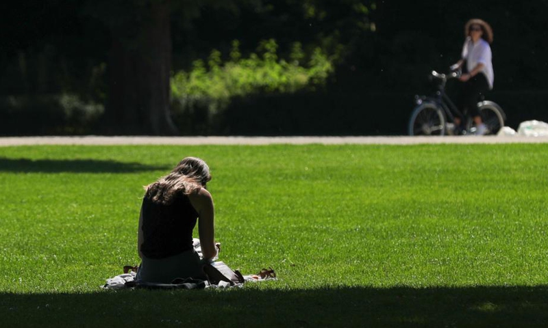 A woman sits in the Park of the Fiftieth Anniversary in Brussels, Belgium, on June 9, 2021. Belgium's summer plan entered into force on Wednesday. The hospitality sector is allowed to reopen indoor areas from 5 a.m. until closing time at 11:30 p.m. The Consultative Committee in Belgium agreed on new travel rules and relaxation plans on June 4 to allow people to travel safely for their summer holidays.   Photo: Xinhua