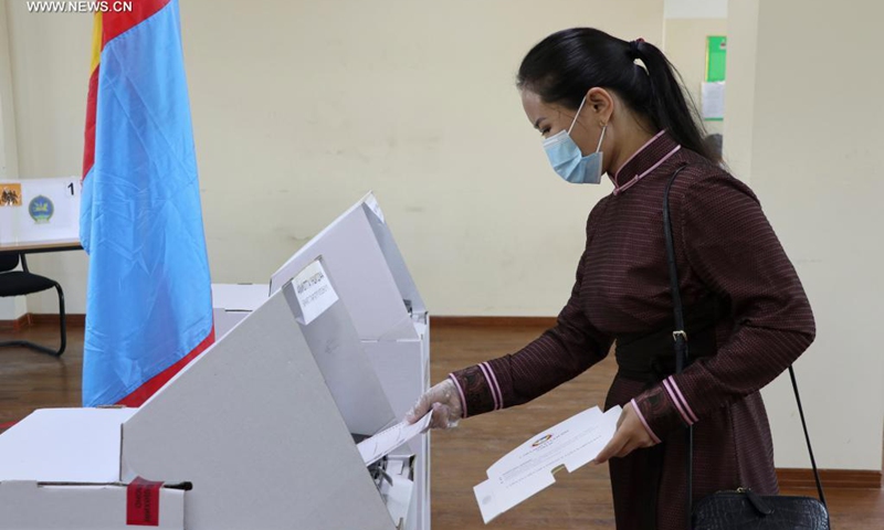 A voter casts her vote at a polling station in Ulan Bator, Mongolia, June 9, 2021. Presidential election kicked off across Mongolia on Wednesday amid the COVID-19 pandemic, with over 2.1 million people eligible to vote.Photo: Xinhua