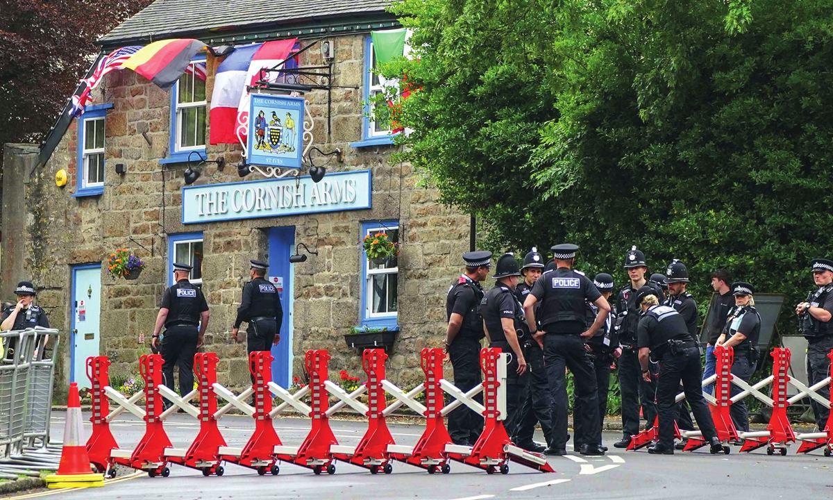 Police gather to patrol a checkpoint in St. Ives, Cornwall, England on Thursday. Security in the area is being tightened ahead of the upcoming G7 meeting taking place in Carbis Bay. G7 leaders and guests will meet in the Cornish resort starting Friday. Photo: AP