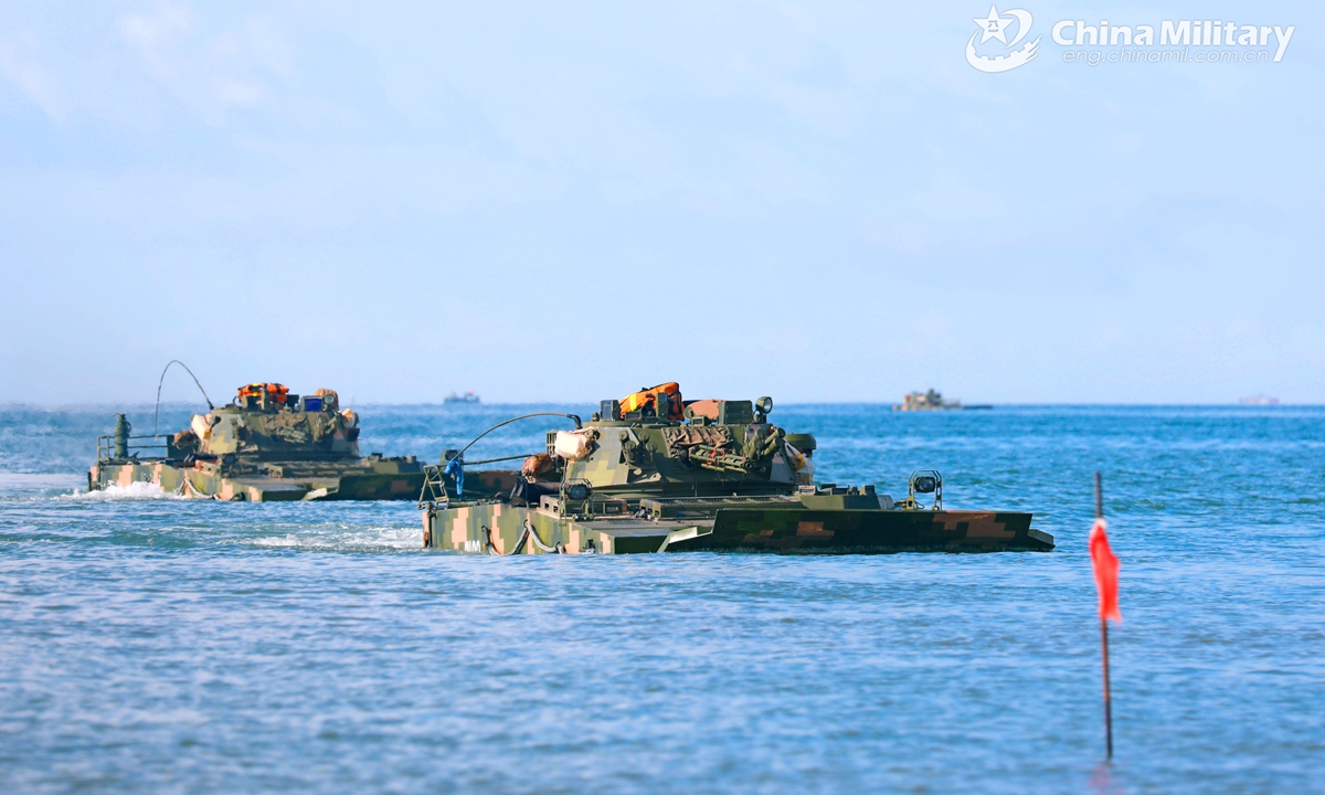 Amphibious armored infantry fighting vehicles (IFV) attached to a brigade under the PLA 72nd Group Army drive into the waters during an amphibious training exercise focused on subjects of basic driving, landing craft ferrying and assault wave formation, etc. on May 21, 2021.Photo:China Military