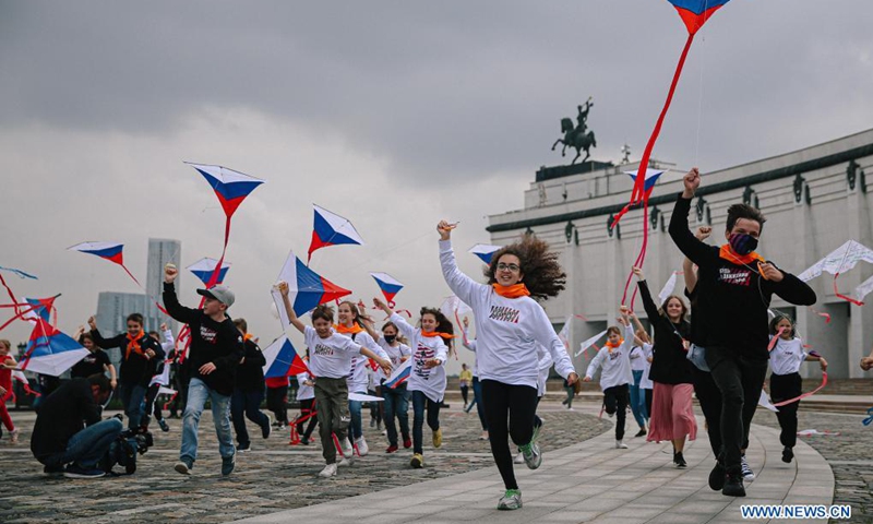 Children run with the kites in colors of Russian flag to celebrate the Russia Day in Moscow, Russia, on June 12, 2021. Russia Day marks the date when the First Congress of People's Deputies of the Russian Federation adopted the Declaration of Russia's National Sovereignty in 1990.Photo:Xinhua