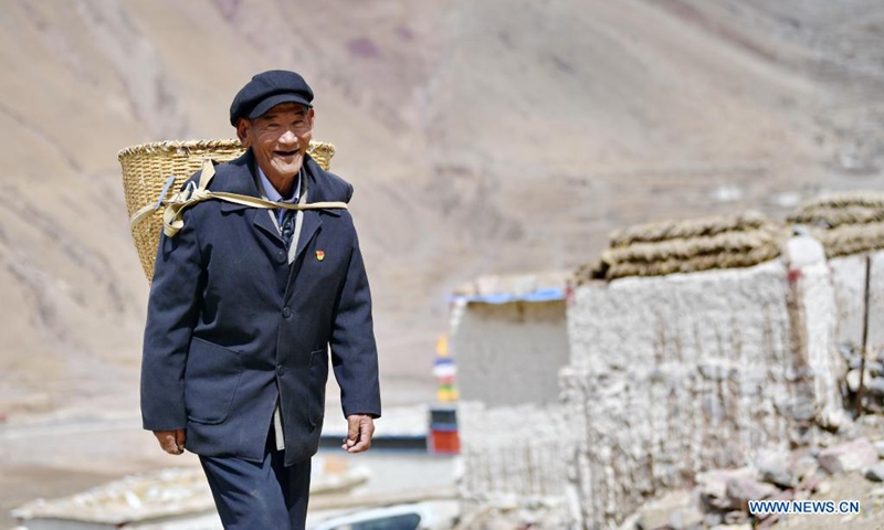 Migmar walks in Lhaya Village, Gyamco Township, Namling County of Xigaze City, southwest China's Tibet Autonomous Region, April 18, 2021.Photo: Xinhua
