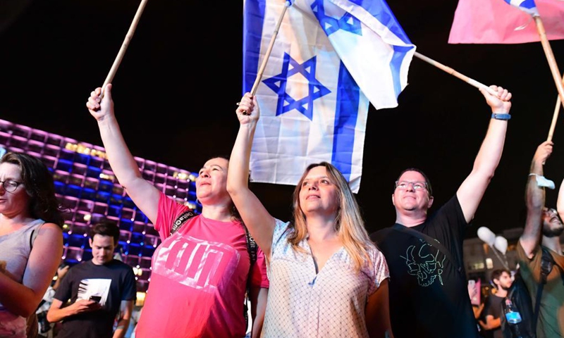 People celebrate after Israel's parliament approved a new coalition government on Rabin Square in Tel Aviv, on June 13, 2021. Naftali Bennett, leader of the right-wing Yamina (United Right) party, was sworn in as new Israeli prime minister on Sunday night, sending Benjamin Netanyahu to the opposition after a record 12-year rule.(Photo: Xinhua)