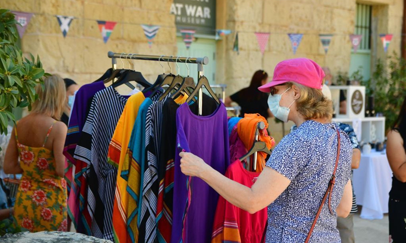 A woman visits the artisan market in Vittoriosa, Malta, on June 13, 2021. The market offers a wide array of products from local makers, designers, artisans and artists. (Photo: Xinhua)