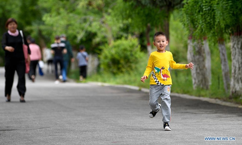 A child plays at Gunzhongkou scenic spot of Helan Mountain in Yinchuan, northwest China's Ningxia Hui Autonomous Region, June 14, 2021. On Monday, China celebrates the Dragon Boat Festival, a traditional festival observed to commemorate Qu Yuan, a well-known patriotic poet from ancient China. (Xinhua/Feng Kaihua)