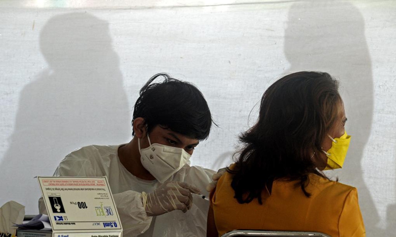 A health worker gives a dose of COVID-19 vaccine to a woman in South Tangerang, Indonesia, June 14, 2021.Photo: Xinhua