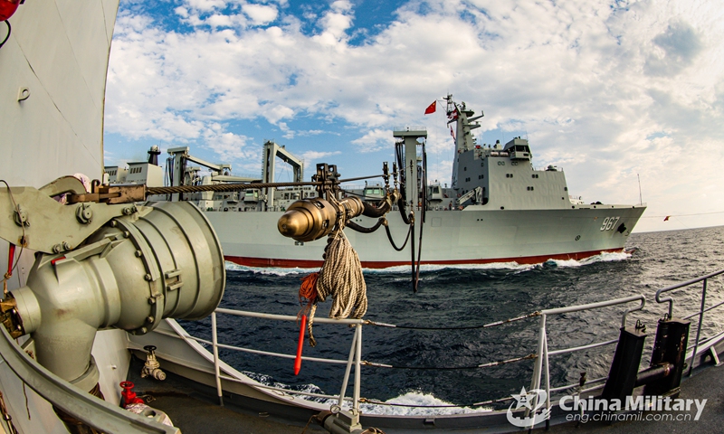 A warship attached to a destroyer flotilla with the navy under the PLA Southern Theater Command receives the refueling probe from the comprehensive supply ship Chaganhu (Hull 967) during a four-day-long realistic-combat training exercise in waters of the South China Sea.(Photo: eng.chinamil.com.cn)