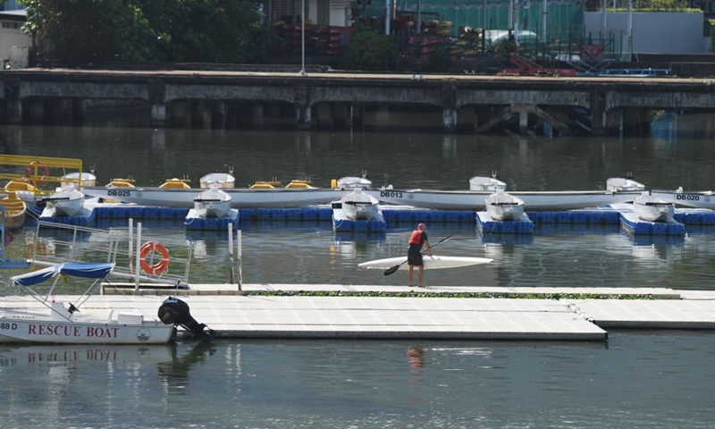 Empty dragon boats are berthed on a floating platform as part of the restrictive measures amid the COVID-19 pandemic, instead of racing during the traditional Dragon Boat Festival, in Singapore's Kallang Basin, June 14, 2021. Photo: VCG