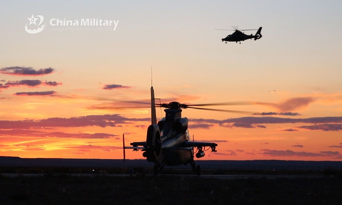 An attack helicopter attached to an army aviation brigade under the PLA 80th Group Army leaves for a flight training task as another helicopter awaiting lift-off order during a live-fire flight training mission on June 5, 2021. (eng.chinamil.com.cn/Photo by Yu Dashuang)