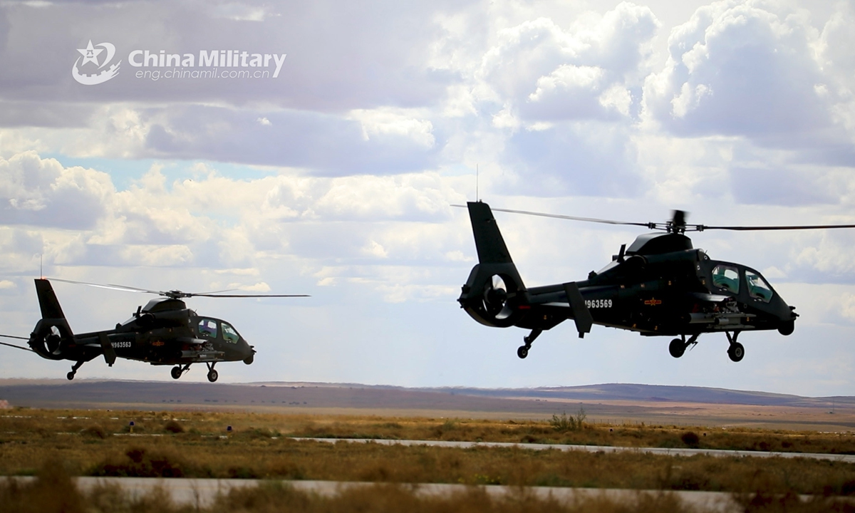 Two attack helicopters attached to an army aviation brigade under the PLA 80th Group Army fly at an ultra-low altitude during a live-fire flight training mission on June 5, 2021. (eng.chinamil.com.cn/Photo by Yu Dashuang)