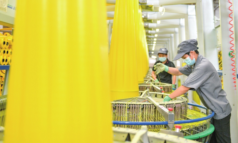 Employees of an environmental technology firm in Huzhou, East China's Zhejiang Province operate high-speed circular looms on Tuesday, churning out plastic bags to be shipped to Indonesia. The firm has introduced a one-stop digital management platform to enable more efficient quality tracing, with its high-tech green packaging items taking a firm hold in the Yangtze River Delta region and being in great demand in markets along the Belt and Road Initiative. Photo: cnsphoto