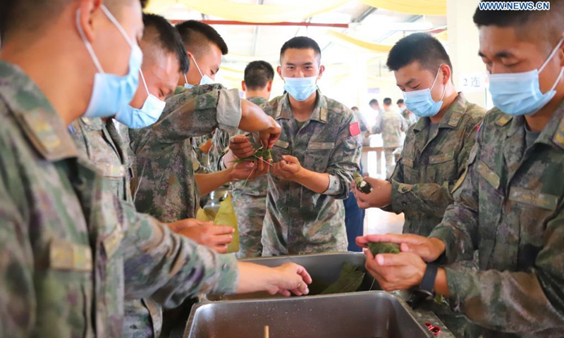 Chinese peacekeepers to Lebanon make rice dumplings on the occasion of the traditional Dragon Boat Festival at a village of south Lebanon's Tyre City, June 13, 2021.(Photo: Xinhua)