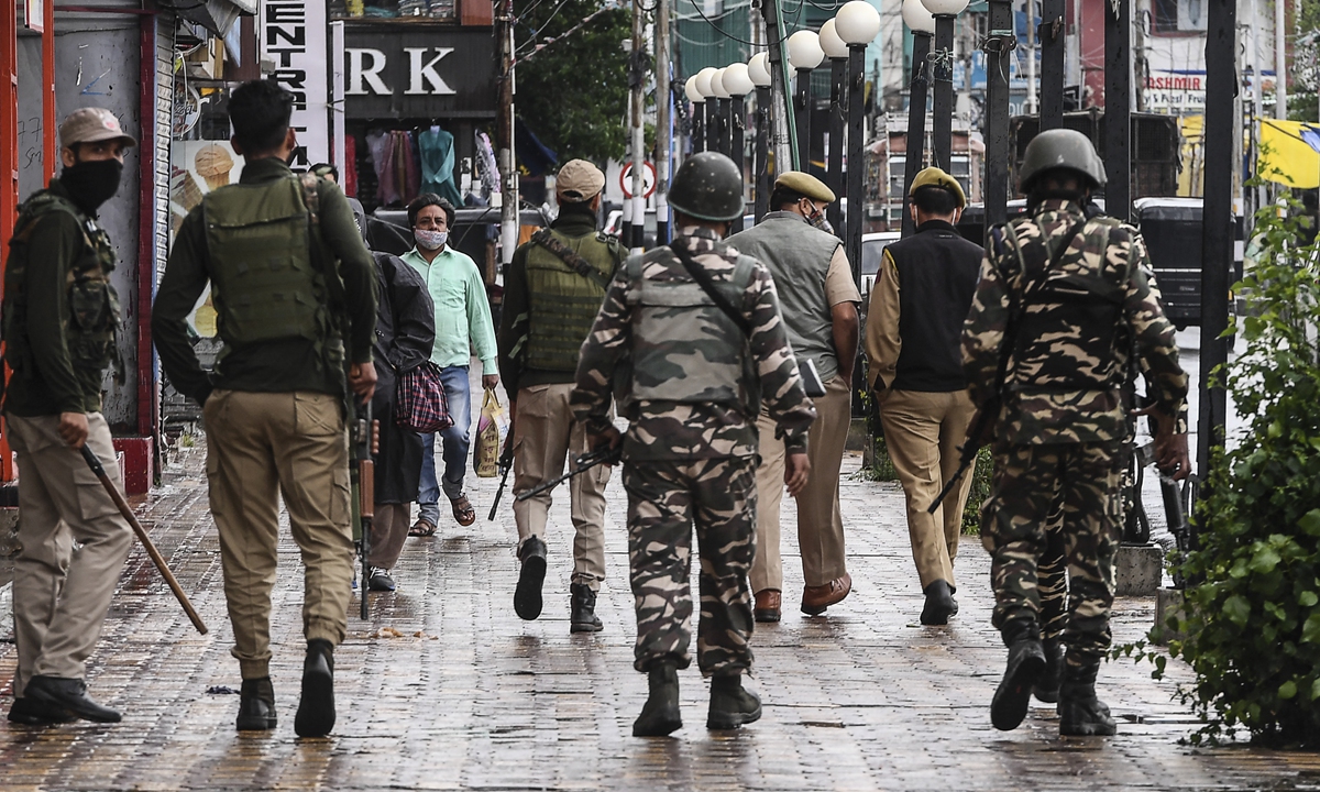 Government forces patrol a area during a rainfall in Srinagar, the summer capital of Indian-controlled Kashmir on Tuesday. Photo: AFP