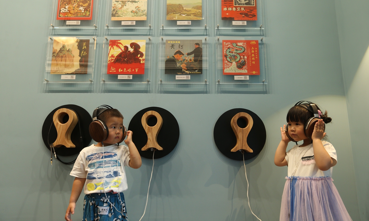 Two children listen to China's national anthem at Shanghai's Pathe Villa, where the anthem was first recorded in 1935. Photo: IC
