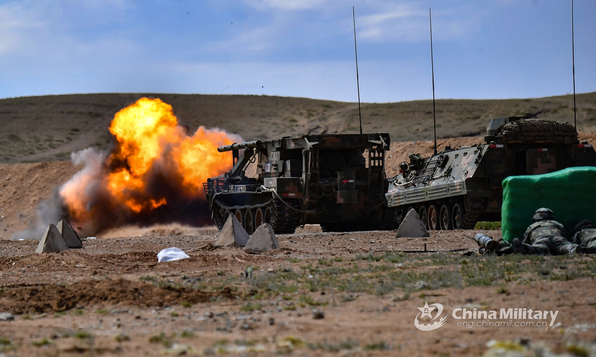 An assault breacher vehicle fires obstacle-breaching shells to clear obstacles in the way during a barrier-breaking training exercise at a comprehensive military training base on June 5, 2021. This training exercise was jointly conducted by a chemical defense detachment and an engineering detachment under the PLA 73rd Group Army. (eng.chinamil.com.cn/Photo by Liu Zhiyong)