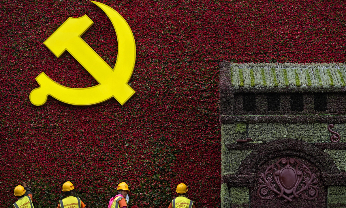 Landscape workers install flowers on a decoration using the symbol of the Communist Party of China (CPC) in Beijing on Wednesday. Authorities are gearing up to mark the 100th anniversary of the founding of the CPC, which will be observed on July 1. Photo: VCG