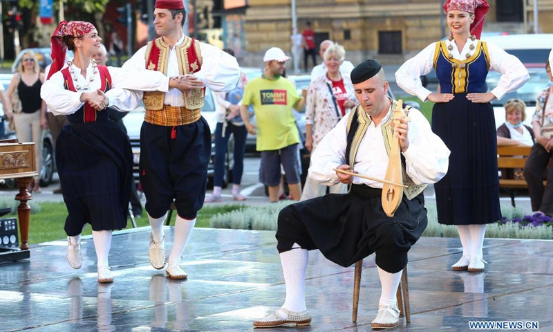 Members of the National Folk Dance Ensemble of Croatia LADO perform on the outdoor summer stage of Croatian National Theater in Zagreb, Croatia, June 16, 2021.(Photo: Xinhua)