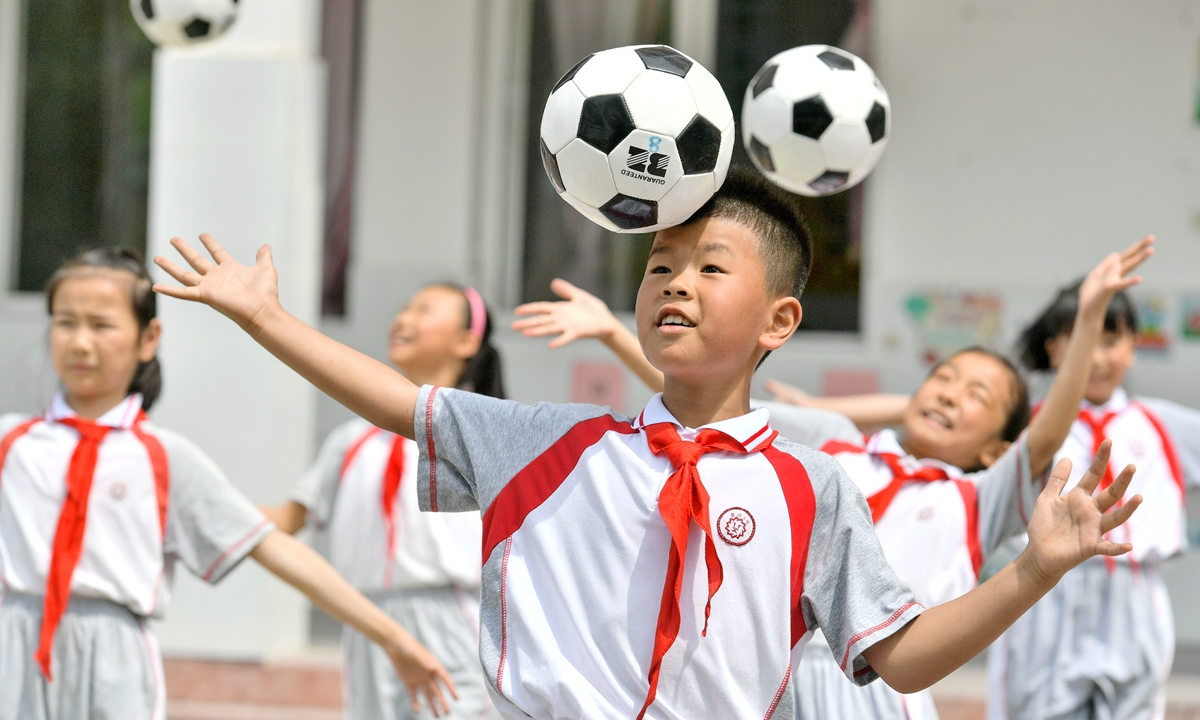 Students play football at a primary school in Huzhou, East China's Zhejiang Province on June 8. Photo: cnsphoto