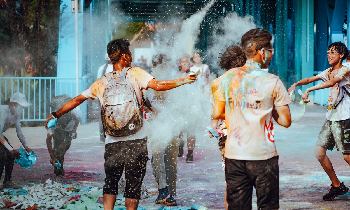 High-school graduates play at a 