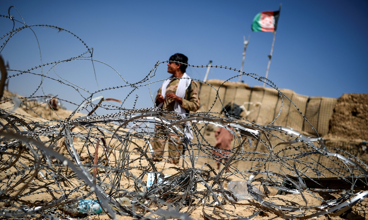 In this photo taken on September 27, 2020, a policeman keeps watch outside an outpost set up against Taliban fighters at Aziz Abad village in Maiwand district of Kandahar province, Afghanistan. Photo: AFP